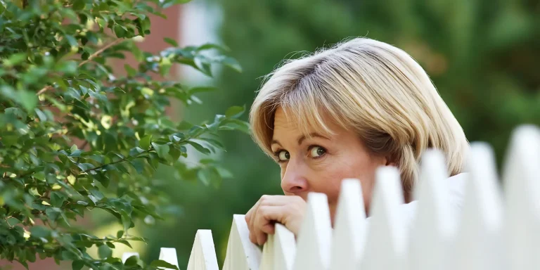 Woman looking over fence